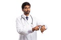 Doctor pointing at watch with serious expression