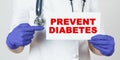 The doctor points his finger at a sign that says - PREVENT DIABETES