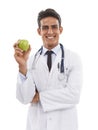 Doctor, portrait and man smile with apple in studio, nutrition and healthy diet or fiber in fruit. Male medical Royalty Free Stock Photo