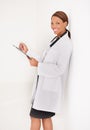 Doctor portrait, woman with documents and writing in medical charts, test results or health evaluation in clinic. Happy