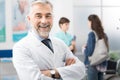 A doctor poses for a portrait and smiles