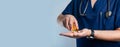 doctor pours multi-colored pills into the palm of his hand and offers them to the patient. Banner, space for text Royalty Free Stock Photo