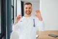 Doctor in PPE holding a vial or bottle vaccine against coronavirus Covid 19 new Omicron variant or strain in his hand, close up. Royalty Free Stock Photo