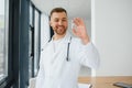 Doctor in PPE holding a vial or bottle vaccine against coronavirus Covid 19 new Omicron variant or strain in his hand Royalty Free Stock Photo