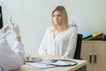 Doctor prepare giving vaccine to scared woman patient with injection or syringe in hospital room Royalty Free Stock Photo