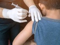 Doctor preparing an injection in the arm boy