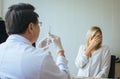 Doctor preparing the medicine or giving vaccine to woman patient with injection or syringe in hospital room Royalty Free Stock Photo