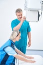 Doctor preparing a patient for a hand x-ray