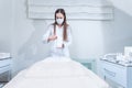 The doctor is preparing to receive a patient in a beauty salon. The woman covers the couch with a protective hygienic white Royalty Free Stock Photo