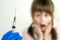 Doctor preparing vaccination injection with a syringe to an afraid child girl. Vaccination of children at school concept Royalty Free Stock Photo