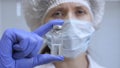 The doctor prescribed an injection treatment. A nurse holds an ampule with medicine in her hand. vaccine for disease in