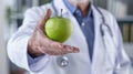Doctor Presenting a Green Apple.AI generated image Royalty Free Stock Photo