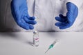 Doctor Presents Sputnik V Vaccine and Syringe - Medical Lab Photo