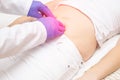 The doctor probes the lower abdomen in a girl who has pain and inflammation of the bladder. The concept of diseases in