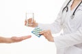 Doctor proposing a glass of water and tablets for patient Royalty Free Stock Photo