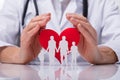 Doctor Protecting Family Cut Out With Heart Shape Royalty Free Stock Photo