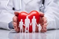 Doctor Protecting Family Cut Out And Heart Shape Royalty Free Stock Photo