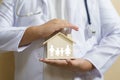 Doctor is protecting house with family paper Health care and Car Royalty Free Stock Photo