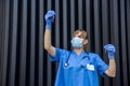 Doctor in protective gloves and mask holding red test tube on abstract background Royalty Free Stock Photo