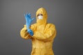 Doctor in protective suit, medical mask, and latex gloves