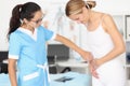 Doctor provides medical assistance to woman with abdominal pain Royalty Free Stock Photo