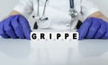 The doctor put together a word from cubes GRIPPE