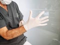 Doctor puts on latex gloves before proceeding to perform his work