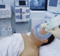 Doctor puts on the patient breathing mask