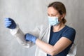 Doctor puts on personal protective equipment PPE due to COVID-19 Royalty Free Stock Photo