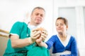 Doctor putting bandage on the injured finger of little girl Royalty Free Stock Photo
