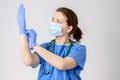 Doctor putting on blue surgical gloves Royalty Free Stock Photo