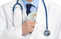 Doctor putting bribe into pocket. Corruption in medicine Royalty Free Stock Photo