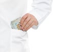 Doctor putting bribe into pocket on white background. Corruption in medicine Royalty Free Stock Photo