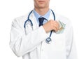 Doctor putting bribe into pocket on white background. Corruption in medicine Royalty Free Stock Photo