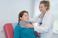 doctor putting patients neck support