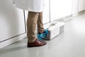 Doctor putting protective shoes on in laboratory