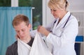 Doctor putting on sling to patient Royalty Free Stock Photo