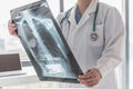 Doctor with radiological chest x-ray film for medical diagnosis on patientÃ¢â¬â¢s health on asthma, lung disease and bone cancer Royalty Free Stock Photo