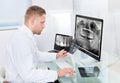 Doctor or radiologist looking at an x-ray online