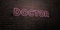 DOCTOR -Realistic Neon Sign on Brick Wall background - 3D rendered royalty free stock image