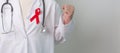 Doctor with Red Ribbon for December World Aids Day, acquired immune deficiency syndrome, multiple myeloma Cancer Awareness month