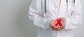 Doctor with Red Ribbon for December World Aids Day, acquired immune deficiency syndrome, multiple myeloma Cancer Awareness month