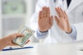 Doctor rejecting bribe in clinic. Corrupted medicine Royalty Free Stock Photo