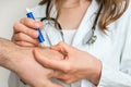 Doctor removing a tick with tweezers from hand of patient Royalty Free Stock Photo