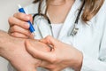 Doctor removing a tick with tweezers from hand of patient Royalty Free Stock Photo