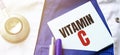 Doctor robe, stethoscope, pens and note with text VITAMIN C Royalty Free Stock Photo
