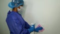 The doctor in rubber gloves disinfects switch with disinfectant and napkins. Convalescence