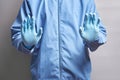 Doctor in rubber gloves holds his hands in front of him. medical worker shows a stop sign. concept Royalty Free Stock Photo