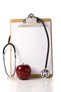 Doctor's Clipboard with an Apple and a Stethoscope