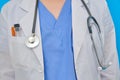 Doctor`s clothing with syringes and test tube in the pocket, close-up. The body of a nurse in a dressing gown and uniform, front